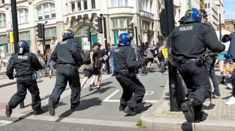 Three charged with violent disorder over Liverpool unrest