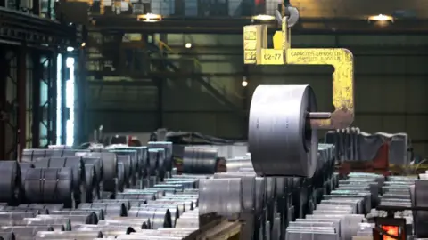 Rolls of steel being lifted at a steel mill in Canada