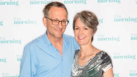 ITV/Shutterstock Michael Mosley with wife Clare Bailey Mosley while on the set of the This Morning TV show in 2019.
