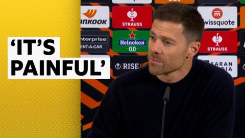 Xabi Alonso in front of sponsor boards at a press conference