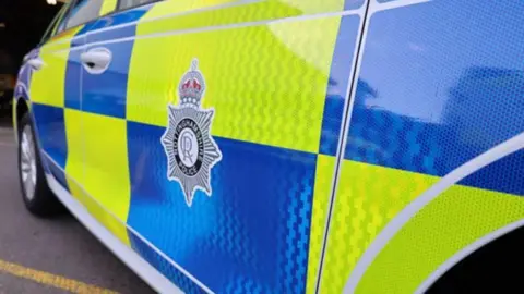 A police car with an image of the Nottinghamshire Police badge