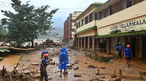 Getty Images Relief workers conduct search and rescue operations at a site following a landslide in Wayanad 