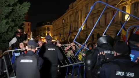 Reuters Protesters clash with riot police in Bucharest, Romania. Photo: 9 March 2025