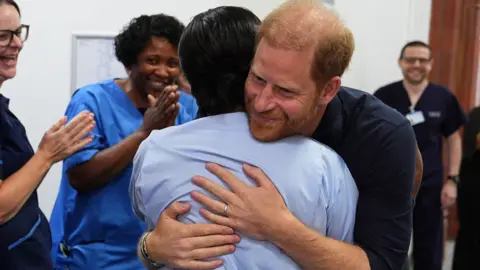 Prince Harry hugs a nurse on his visit to Birmingham Children's Hospital