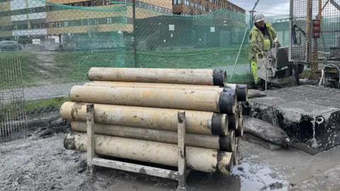 BBC Pipes beside a borehole drill