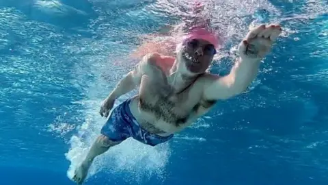BBC A man swimming