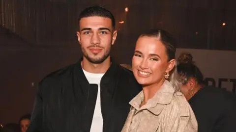 David M. Benett/Dave Benett/Getty Images for PrettyLittleThing Tommy Fury and Molly-Mae Hague attend the PrettyLittleThing X Molly-Mae show at The Londoner Hotel on February 16, 2022 in London, England. 