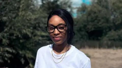 BBC News Natasha, wearing a white top and glasses