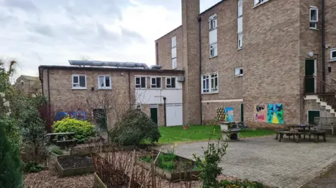 A general view picture of the Willow House site, a grey four-storey building.