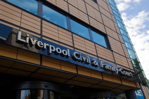 Alamy A tall brown building with the lettering "Liverpool Civil & Family Court"