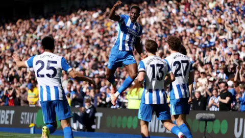 Brighton and Hove Albion players celebrating a goal.