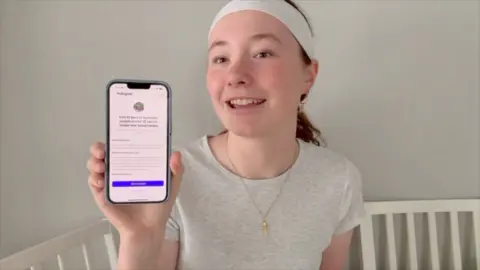 Teenage girl holding up phone with her blocked Instagram account