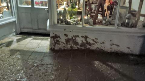 Slurry on a shop front and pavement