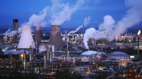 Chimneys and pipes in the Grangemouth plant lighted by PA Media Lights