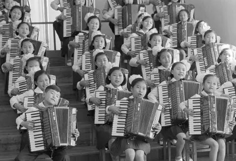 AP Photo/Peter Arnett/File North Korean youngsters sing and play accordions to entertain foreign visitors including United Nations Secretary General Kurt Waldheim, who visited Pyongyang, May 4, 1979.