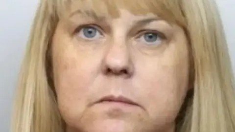 Mugshot of Jacqueline Fletcher, a woman with long blonde hair.
