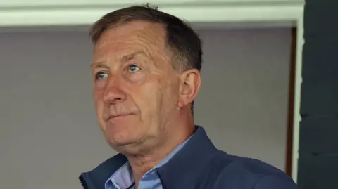 Huw Jenkins looks on from the stands