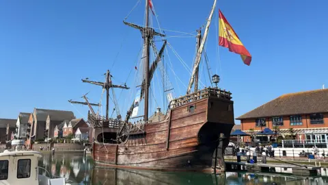 The 28m ship docked in Eastbourne's Sovereign Harbour. It's made of wood and has two large masts and a big Spanish flag the size of a car 