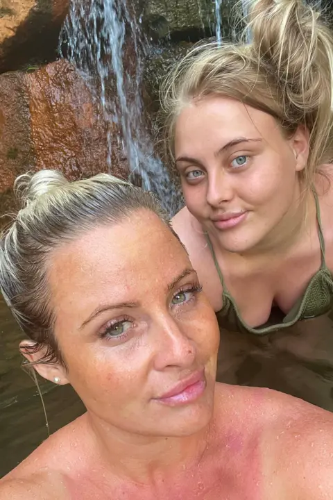 Danielle O'Halloran Selfie of Danielle and Chloe swimming in a lake. They are both smiling looking at the camera.
