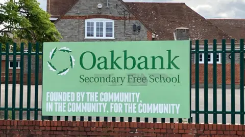 Oakbank Secondary School sign which says: Founded by the community, in the community, for the community