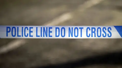A blue and white police tape with the word: 'POLICE LINE DO NOT CROSS'