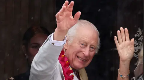 Reuters King Charles waves while boarding a plane