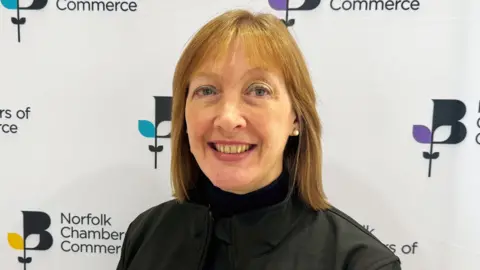 Norfolk Chambers of Commerce Nova Fairbank smiling in a black jacket 