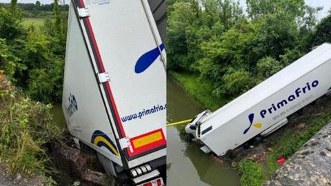 A lorry on a steep slope, with the cab in a canal
