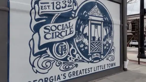 Reuters A blue and white mural depicts Social Circle's historic well