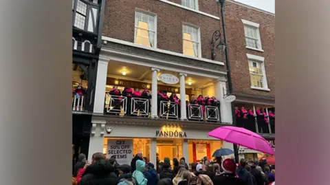 Pop up choirs singing on the Rows as people watch from below