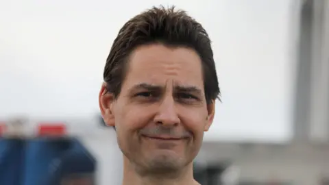 Reuters Close up of Michael Kovrig, faintly smiling, in Toronto following his release from detention in China in September 2021.