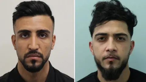 Met Police Two men feature in this police mugshot, on the left is a man with a groomed appearance with a quiff in his hair and a neat, trimmed beard and moustache. His face is solemn and serious. On the right is a man with a more dishevelled appearance, his hair is more windswept and his beard is not as neatly groomed. He has the same solemn facial expression. Both are Afghans.
