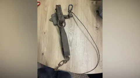 Lancashire Constabulary Spring-loaded trap on a wooden table