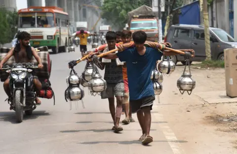 Getty Images Kanwarias coming with Kanwar from Haridwar, on July 21, 2024 in Ghaziabad, India. 