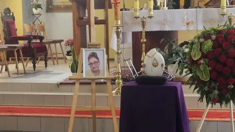 Supplied A framed picture of Izabela Chalastra in a church.