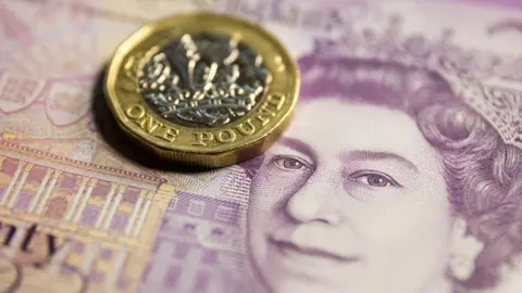 Getty Images Pound coin and twenty pound note