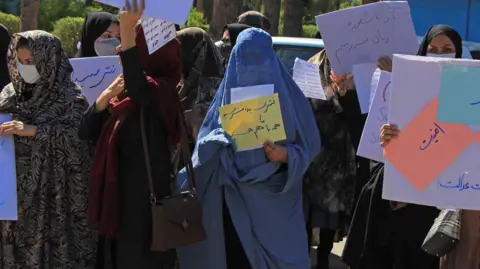 2021 年 9 月 2 日，阿富汗妇女在赫拉特参加抗议活动时举着标语牌