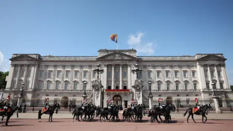 Neil Hall/EPA-EFE/Shutterstock Members of the Household Division parade in front of Buckingham Palace during the Trooping the Colour ceremony in London