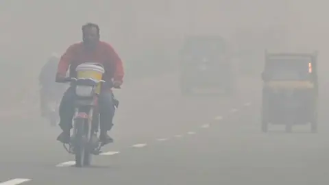 EPA A man rides a bicycle amid heavy smog in Lahore, Pakistan