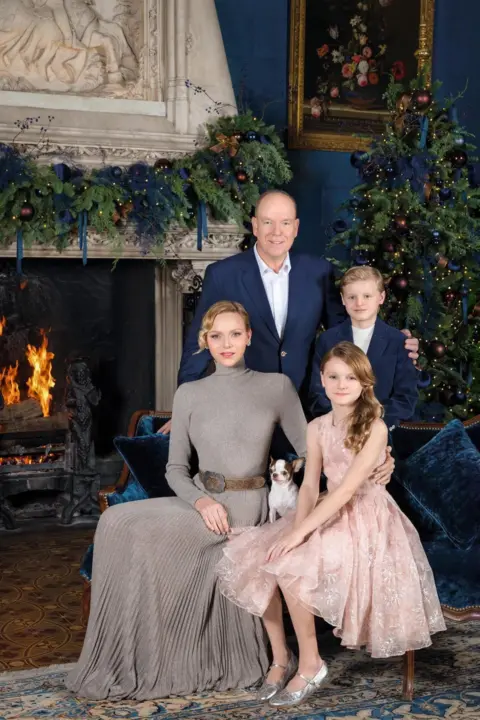 Vanessa Von Zitzewitz/ Palais Princier Monaco royal Christmas card with family in formal clothes by a log fire