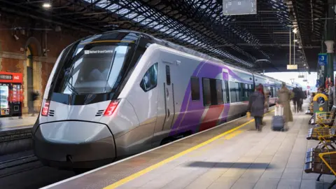 A high-speed train is pulling into Grand Central Station in Belfast. It is grey and has purple and red accents on the doors. 