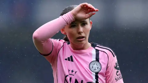 Hannah Cain with hand across forehead