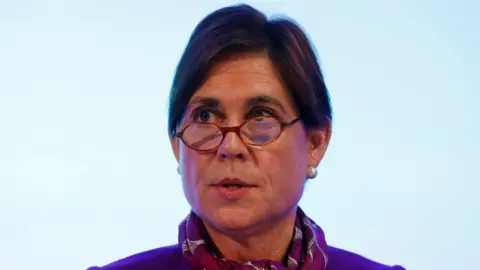 Getty Images A headshot of Baroness Kate Lampard wearing a pashmina, peering over her small, round-framed glasses.