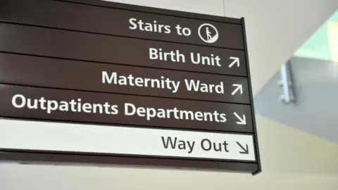 A sign for the Birth Unit, Maternity Ward and Outpatients Department at the Women's Centre at the Royal Gloucestershire Hospital