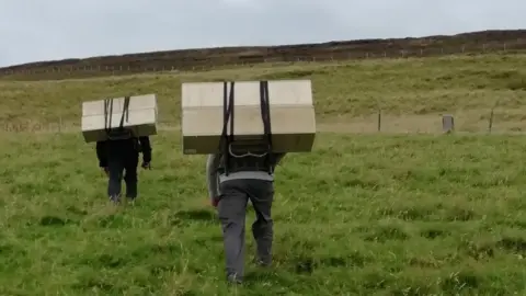 Orkney Native Wildlife Project team moving equipment