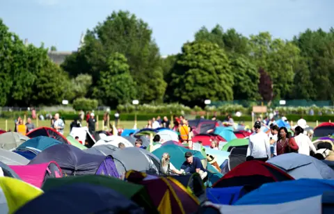 PA Media A sea of colourful tents fill up the campsite at the Wimbledon queue