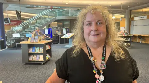 Maddy Jennings/BBC Anne Tidd inside the Millennium Library