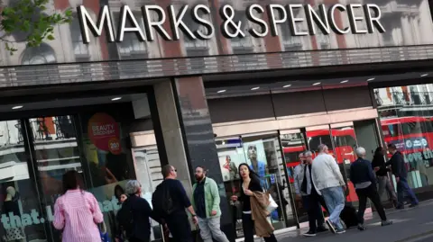 EPA People walking past a Marks & Spencer store