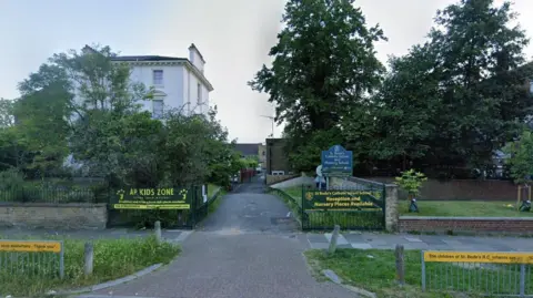 The front view of St Bede's school can be seen, including school signs