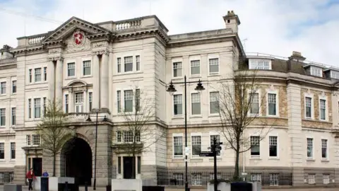 The front of Kent County Council's offices. It is a large, white, regal building.